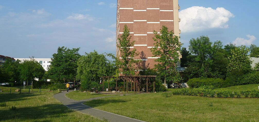 green area between mid-rise residential buildings