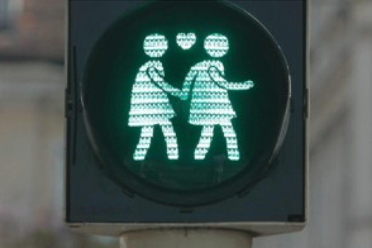 Green traffic light with an icon of two women in love 