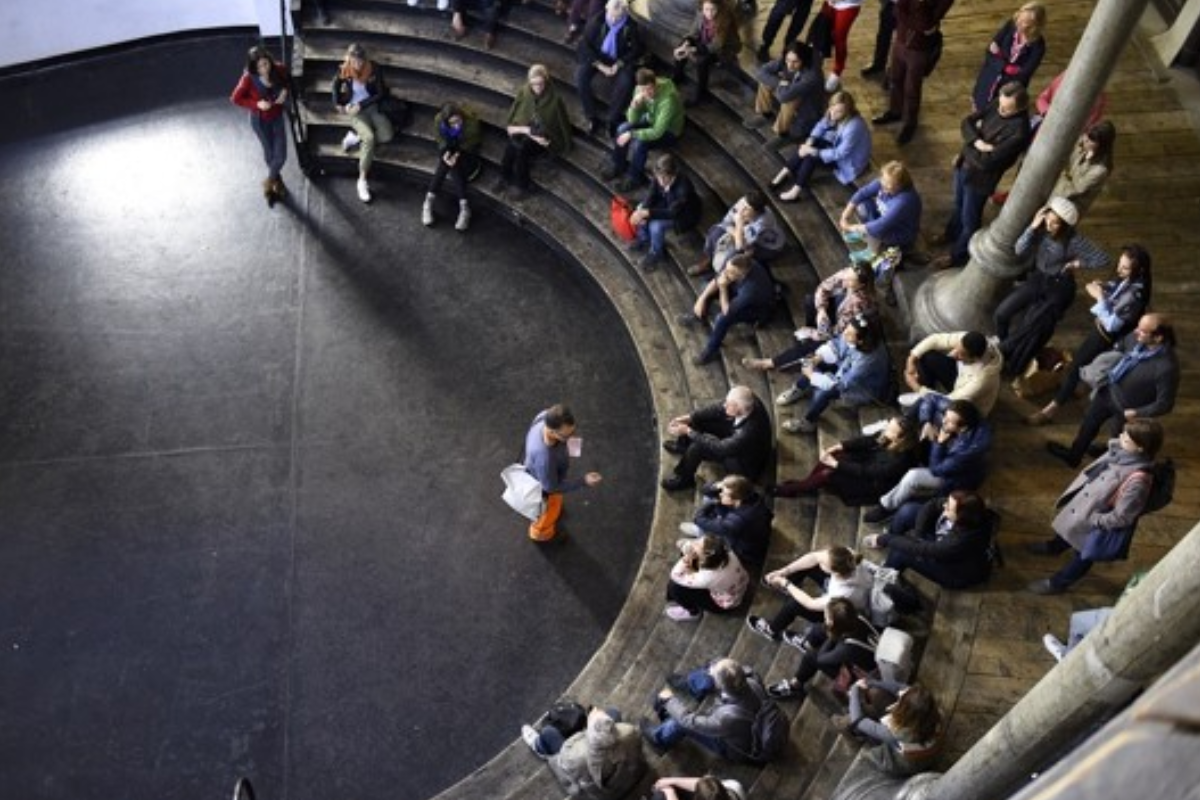 People sitting in a circle discussing photographed from above